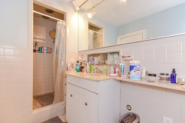 bathroom featuring vanity, tile walls, and a shower stall