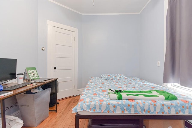 bedroom featuring light wood-style floors and ornamental molding