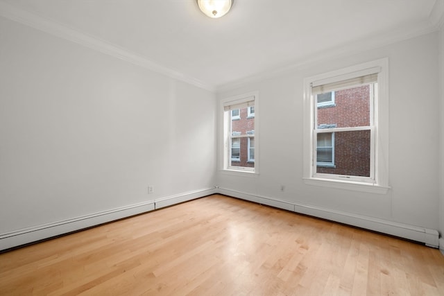 empty room featuring light wood-type flooring and crown molding