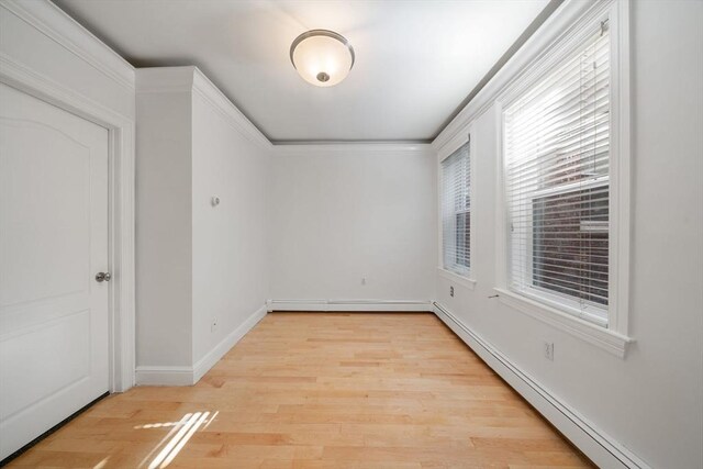 spare room with light hardwood / wood-style flooring and baseboard heating