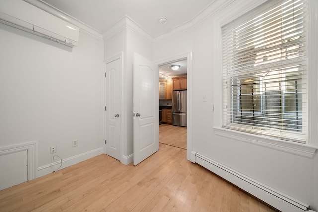 unfurnished room featuring light wood-type flooring, an AC wall unit, ornamental molding, and baseboard heating