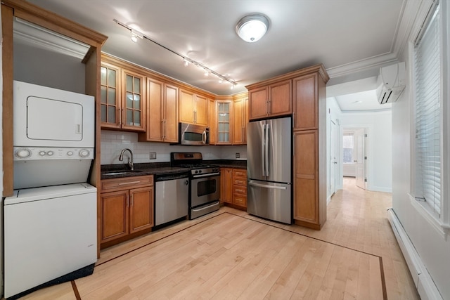 kitchen featuring sink, light hardwood / wood-style floors, a baseboard heating unit, track lighting, and stainless steel appliances