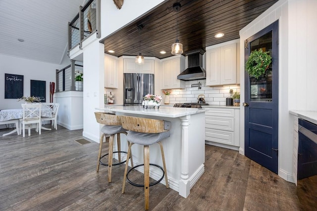 20 Bailey Shr, Hampstead, NH 03841 - kitchen featuring stainless steel fridge with ice dispenser, wall chimney range hood, light countertops, dark wood-type flooring, and backsplash