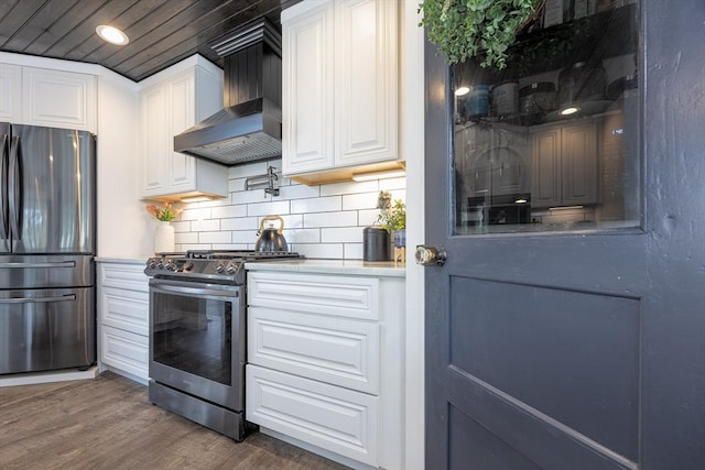 20 Bailey Shr, Hampstead, NH 03841 - kitchen with freestanding refrigerator, stainless steel gas stove, wall chimney exhaust hood, wood finished floors, and white cabinetry