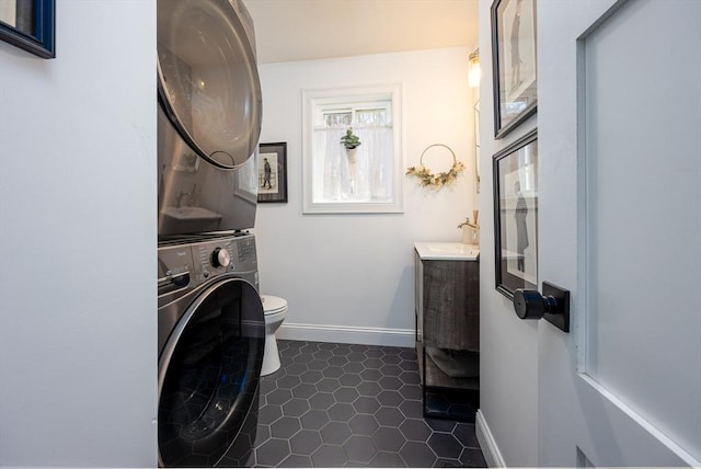 20 Bailey Shr, Hampstead, NH 03841 - laundry area with stacked washer / drying machine, dark tile patterned floors, and baseboards