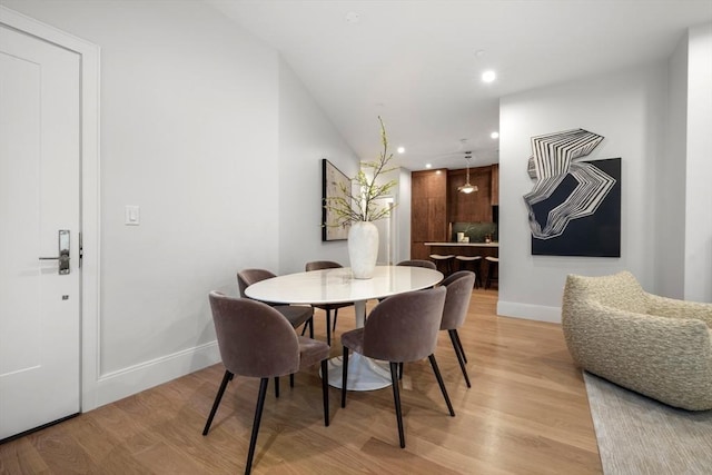 dining area with baseboards, recessed lighting, and light wood-style floors