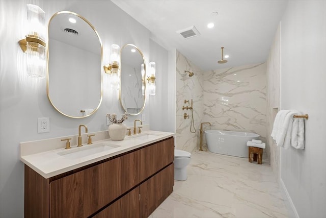 full bath with visible vents, a sink, a freestanding tub, and double vanity