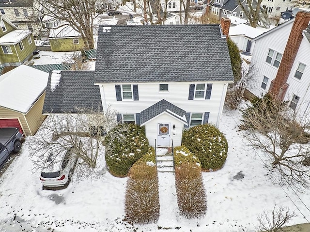 snowy aerial view with a residential view