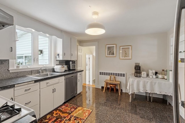 kitchen with dark countertops, white cabinets, granite finish floor, and stainless steel dishwasher