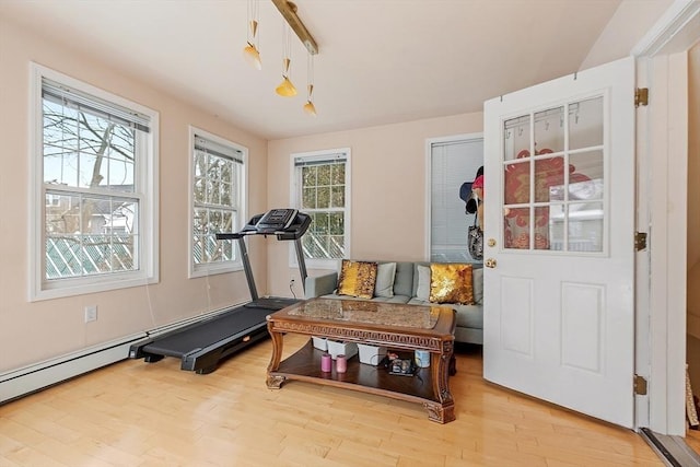 workout room with light wood finished floors