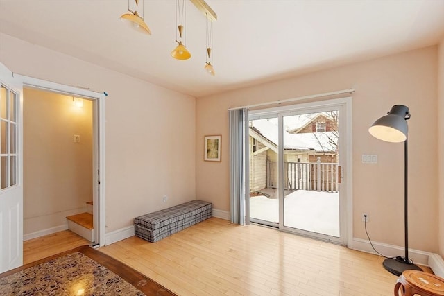 entryway featuring hardwood / wood-style floors, stairway, and baseboards