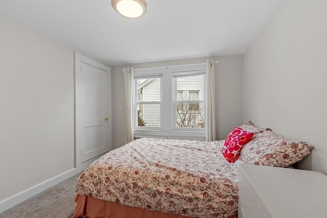 carpeted bedroom with baseboards