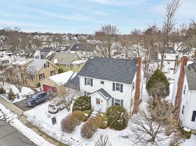 snowy aerial view featuring a residential view