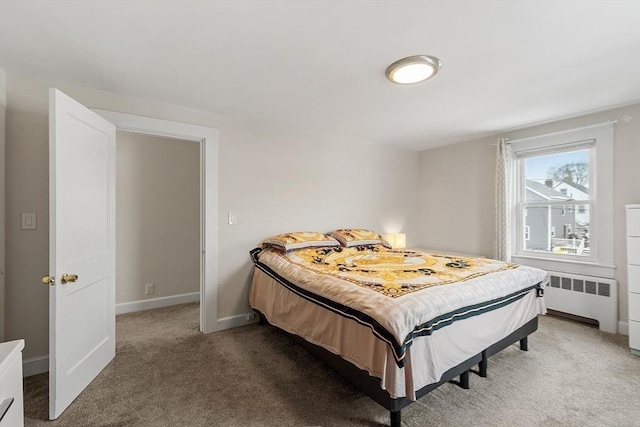 bedroom featuring dark colored carpet, baseboards, and radiator heating unit