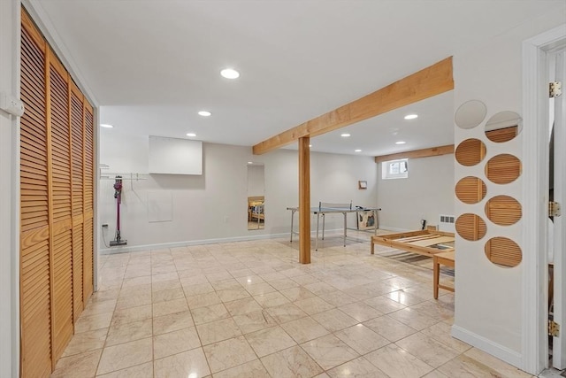 basement with baseboards and recessed lighting