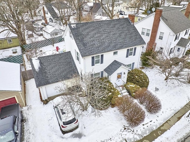 snowy aerial view with a residential view