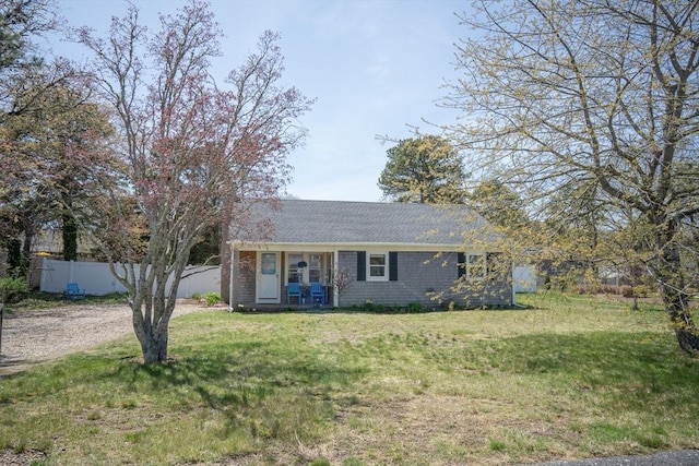 single story home with a front lawn, fence, and driveway