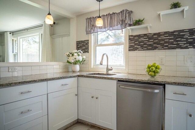 kitchen featuring a sink, tasteful backsplash, white cabinets, and dishwasher