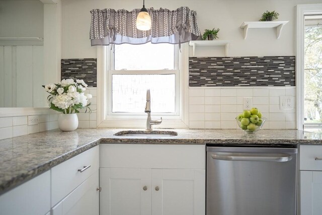kitchen featuring decorative backsplash, stainless steel dishwasher, open shelves, a sink, and white cabinets