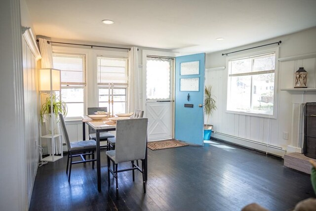 dining space featuring dark wood finished floors and a baseboard radiator