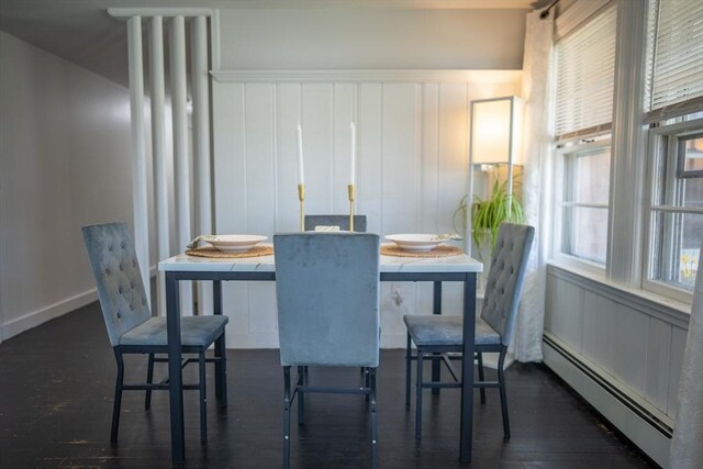 dining area with baseboards, a baseboard radiator, and dark wood-type flooring