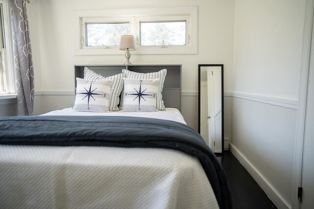 bedroom featuring baseboards and dark wood finished floors