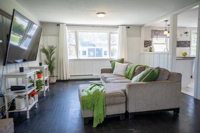 living room featuring a baseboard radiator, dark wood-style flooring, and a baseboard heating unit
