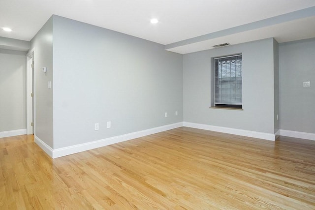 empty room featuring baseboards, recessed lighting, light wood-style floors, and visible vents
