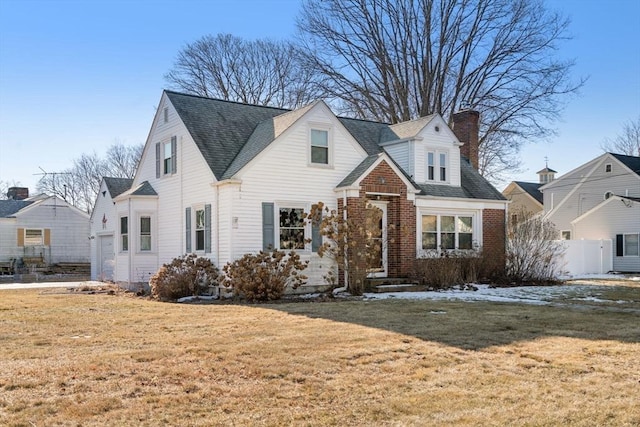 cape cod house with a garage and a front lawn