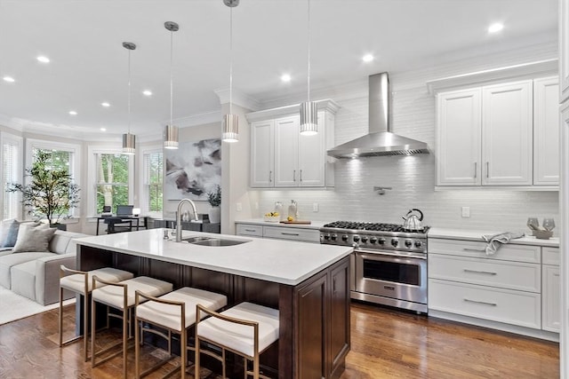 33 Winthrop Unit 1, Brookline, MA 02445 - kitchen with wall chimney exhaust hood, stainless steel range, a sink, light countertops, and tasteful backsplash