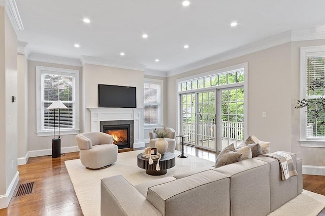 33 Winthrop Unit 1, Brookline, MA 02445 - living room with healthy amount of natural light, baseboards, a warm lit fireplace, wood finished floors, and recessed lighting