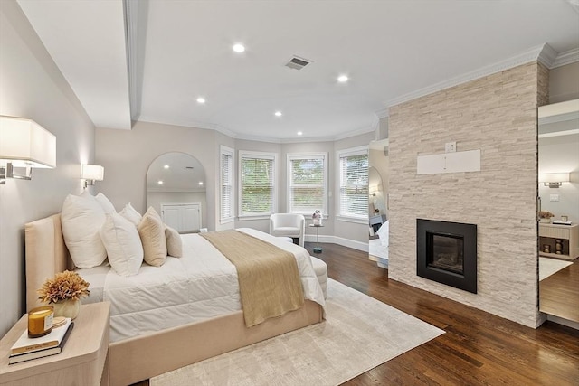 33 Winthrop Unit 1, Brookline, MA 02445 - bedroom featuring a stone fireplace, dark wood-type flooring, recessed lighting, ornamental molding, and baseboards