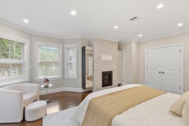 33 Winthrop Unit 1, Brookline, MA 02445 - bedroom with dark wood-style floors, baseboards, a large fireplace, crown molding, and recessed lighting