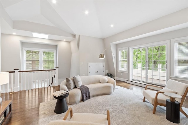 33 Winthrop Unit 1, Brookline, MA 02445 - living room featuring healthy amount of natural light, wood finished floors, vaulted ceiling, recessed lighting, and a baseboard heating unit