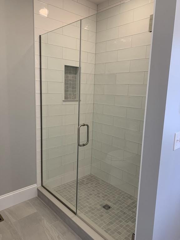 bathroom with tile patterned floors and a shower with shower door