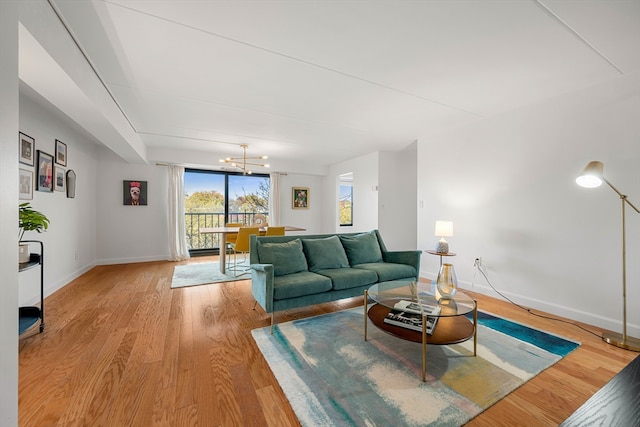 living room featuring light hardwood / wood-style flooring and a chandelier