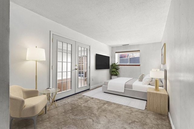 carpeted bedroom featuring french doors, access to exterior, and a textured ceiling