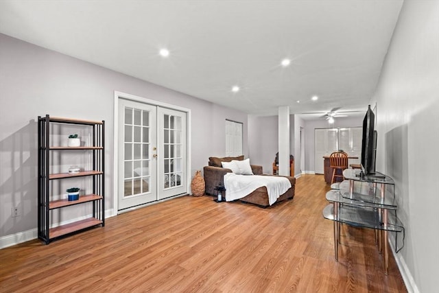 living room featuring light hardwood / wood-style flooring, ceiling fan, and french doors