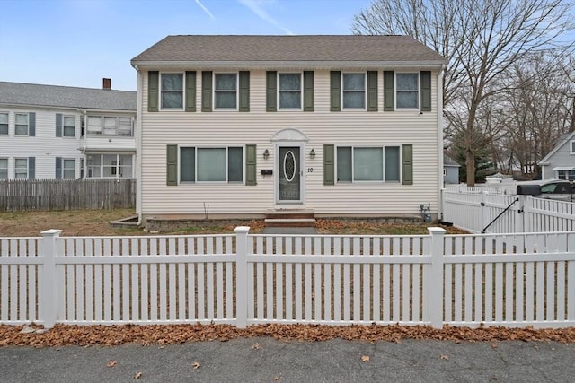 view of front of property featuring a fenced front yard and a gate