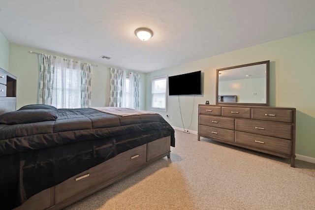 bedroom featuring light colored carpet, visible vents, and baseboards