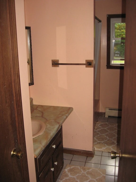 bathroom with vanity, a baseboard radiator, and tile patterned floors