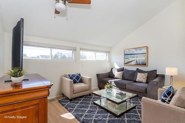 living area with lofted ceiling, visible vents, light wood-type flooring, and ceiling fan