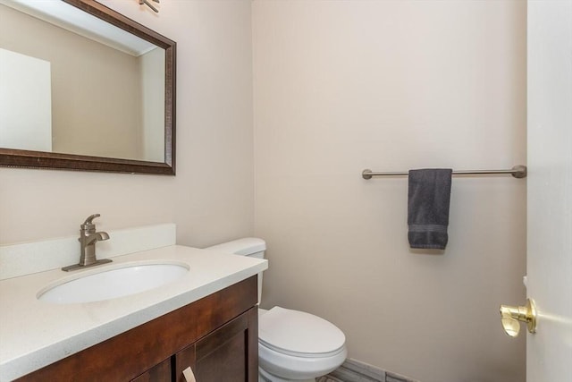 bathroom featuring toilet and vanity