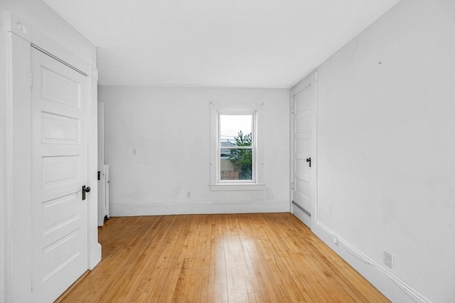 unfurnished room featuring light wood-type flooring and baseboards