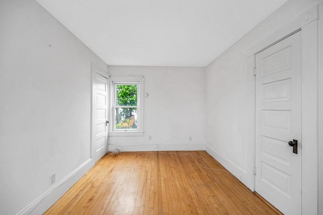 spare room with light wood-style flooring and baseboards
