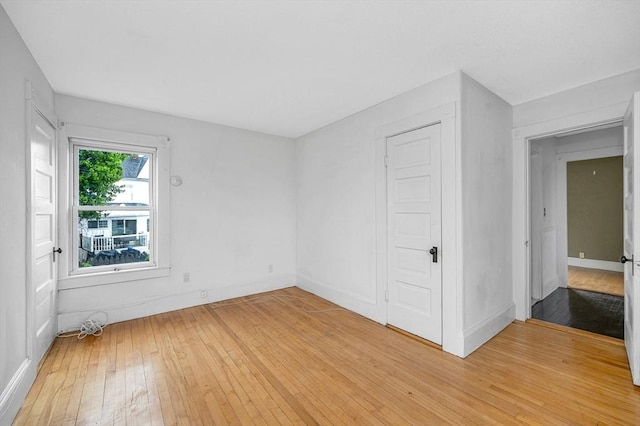 unfurnished room featuring light wood-style floors and baseboards