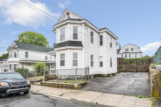 view of front of home featuring fence