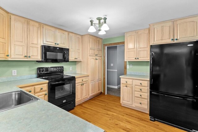 15 Cushing St, Salisbury, MA 01952 - kitchen with black appliances, light brown cabinets, light countertops, and light wood-style flooring