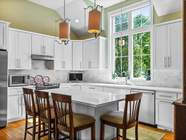 8 Sandstone Dr Unit 8, Medway, MA 02053 - kitchen with appliances with stainless steel finishes, a sink, white cabinets, under cabinet range hood, and a kitchen breakfast bar