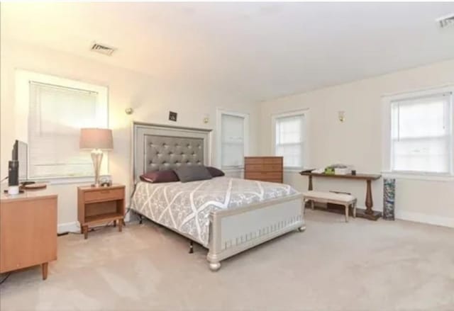 75 William St, Worcester, MA 01609 - bedroom featuring light carpet, baseboards, multiple windows, and visible vents